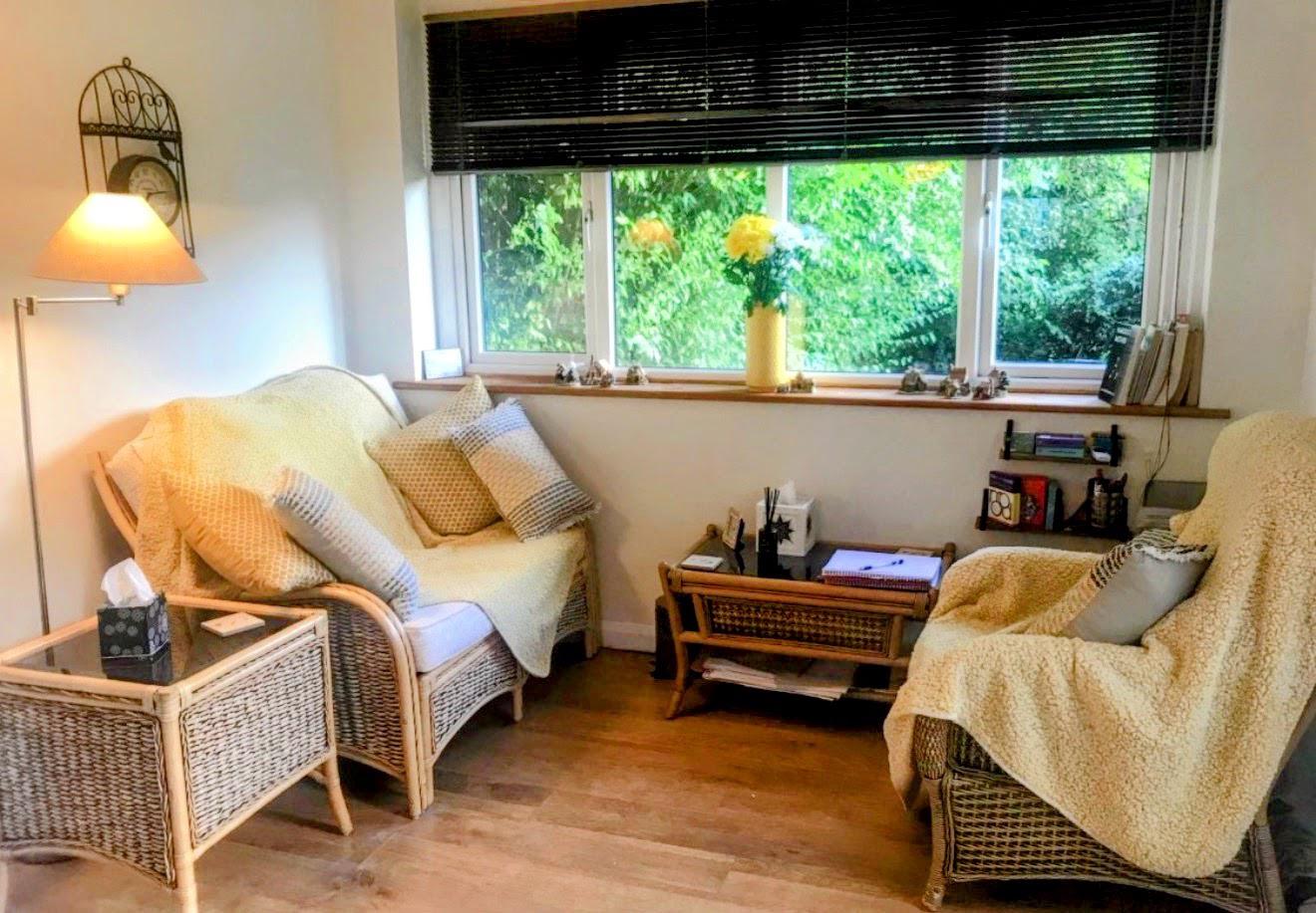 Ali's therapy room, with wicker chairs and a window onto the garden